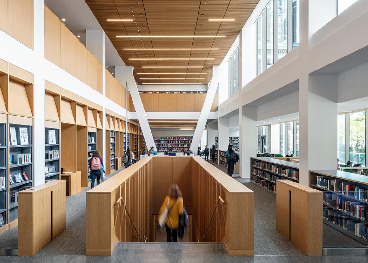 interior view of the library with someone walking down a staircase